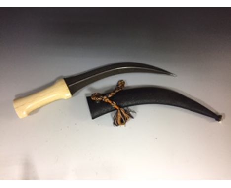 A 19th century bone handled jambiya, with damascus blade, the leather scabbard with white paste jewelled tip  