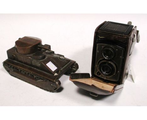 A brass model of a Vickers medium tank, the push down barrel opening a lid, 18cm long, together with a Rolleicord camera, in 