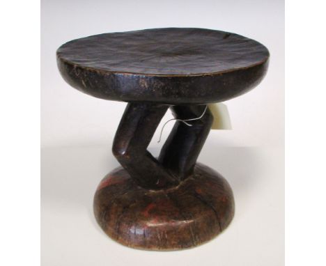An east African carved hardwood stool, first half of the 20th century, traces of polychrome decoration, 18.2cm (7in) high  