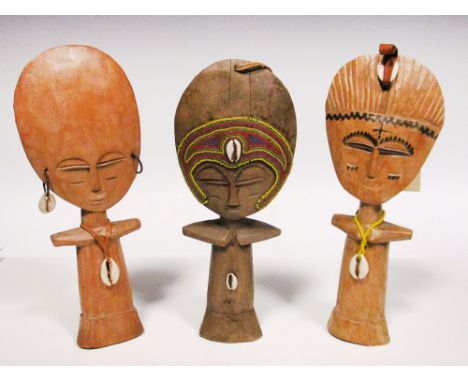 Three carved blond wood maternity figures 'Acuaba', Asante people, Ghana, embellished with cowrie shells, glass trade beads a