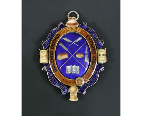 A 1938 Bakery Trade Executives Guild enamel and silver backed badge, the central blue ground enamelled in colours with bakery