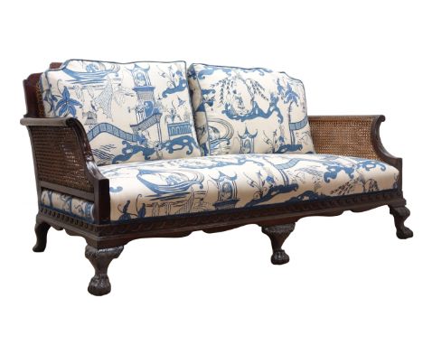 Edwardian George lll style mahogany double caned bergere sofa, moulded frame with Vitruvian scroll frieze on cabriole legs wi