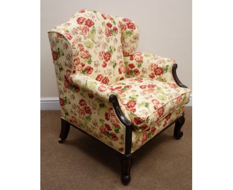 Early Victorian mahogany low upholstered armchair, arched wing back and loose seat cushion in vintage floral Sotherton fabric