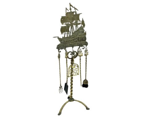 Early 20th century Dutch cast brass fireside companion stand, the galleon surmount supporting five fire tools, raised on a sp