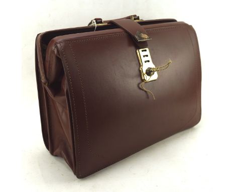 A vintage 1960's/ 70's leather travelling bag, with cheney locks, 44cm wide