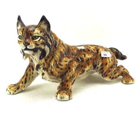 A large ceramic model of a striding lynx, 25cm x 45cm