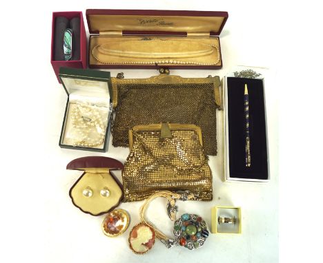 A domed box of vintage jewellery, including two gold coloured clutch bags, necklaces, strings of beads and more