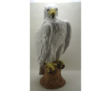 A large ceramic model of a white feathered bird of prey perching on a rock, height 71cm