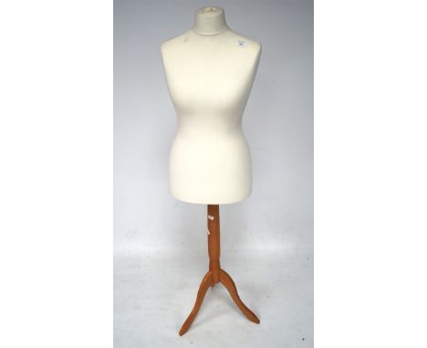 A modern dressmakers mannequin, raised upon tripod supports, 140cm high