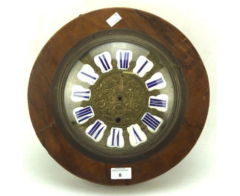 An early 20th century wooden cased wall clock, with blue and white enamel Roman numerals denoting hours, the gilt face with r