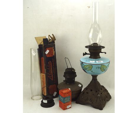 A Victorian oil lamp with blue opaline glass reservoir, on a pierced cast iron base, together with accessories