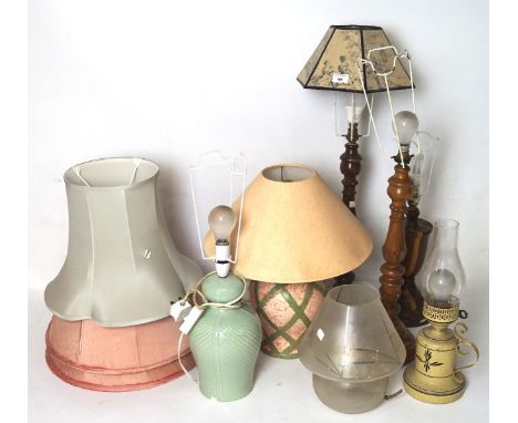 Seven contemporary table lamps, three with wooden stands, three with ceramic bases and a glass base, together with some shade