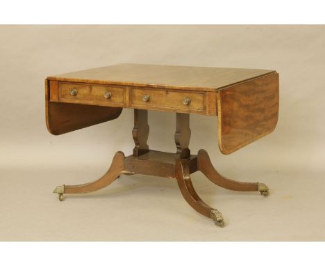 A George III mahogany and cross banded sofa table, two drawers to one side and dummy drawers to the other on two lyre shaped 