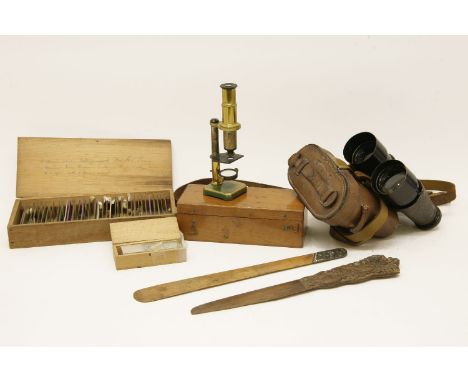 A late 19th century cedar cased brass microscope, with mirror, inscribed verso R Howard, 15cm high, together with various sli