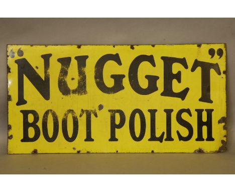 An Edwardian large enamel advertising sign for 'Nugget Boot Polish', with black lettering on a yellow ground