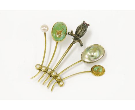 Five stick pins later converted to a brooch, including a silver gilt baroque pearl example, a turquoise cabochon stick pin, a