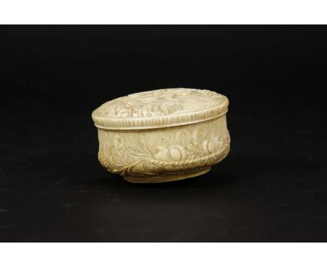 A European carved ivory trinket box, probably 18th century, the circular lid carved with a couple in a landscape, the body ca