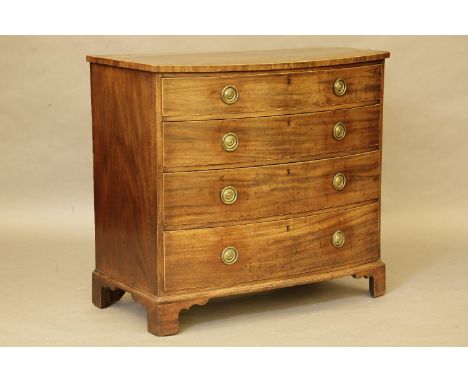 A George III mahogany bow front chest, of four graduated drawers, with brass ring handles, and bracket feet, 101 x 93 x 57cm