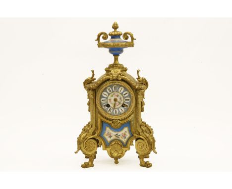 A gilt metal and porcelain mantle clock, the panels in the manner of Sevres