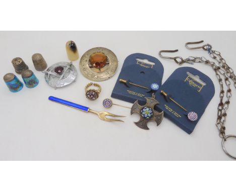 A collection of Caithness jewellery to include a silver cross with Birmingham hallmarks for 1975, a collection of thimbles to