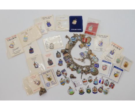 An extensive silver and enamel place name and charm bracelet, to include some unusual charms to include BEA Airlines, Bungay,