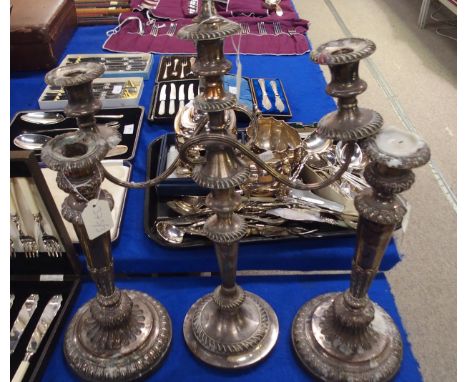 A pair of Victorian EPNS candlesticks, of faceted form, with fluted base, 34.5cm, and a three light candelabrum, with a gadro
