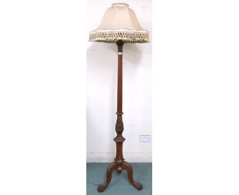 An early 20th century mahogany standard lamp with carved reeded column upright on tripod base terminating in paw feet, 190cm 