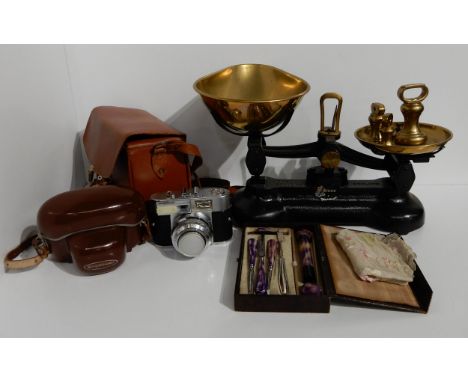 A set of Libra kitchen scales with brass weights, brass handbell, two larger brass bells, a Voigtlander Vitomatic II camera i