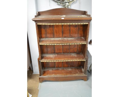 A 20th Century stained pine open bookcase, with raised gallery above three open shelves, raised on shaped bracket feet, 137 x