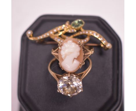 An Edwardian brooch, set oval facet cut aquamarine and seed pearls, stamped '15ct'; a carved shell cameo ring, the yellow met