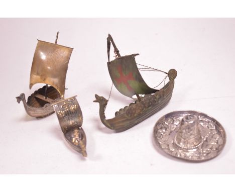 A Japanese model of a boat; a Norwegian model of a Viking ship; a bronze model of a Viking ship; and a Mexican silver model o