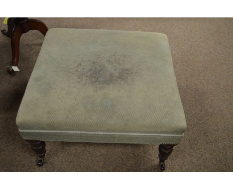 A modern green upholstered stool, raised on turned mahogany legs terminating in brass caps and ceramic castors, 38 x 70 x 69c