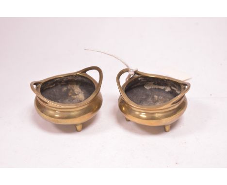 A pair of small Chinese bronze censers, of two-handled cauldron form, with six character marks to base.