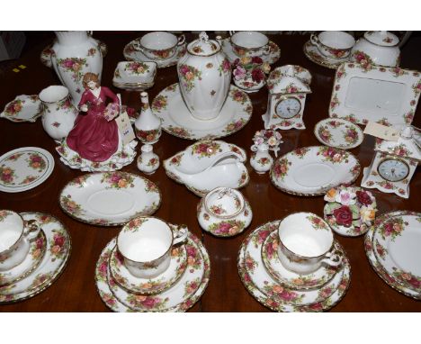 A large collection of Royal Albert Old Country Roses, to include: tea service, mantel clocks, vases, condiments, trays, wall 