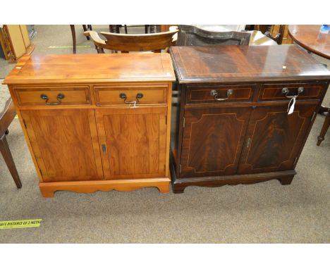 A 20th Century yew wood side cabinet, the moulded top with ebony stringing above two frieze drawers and a pair of cupboard do