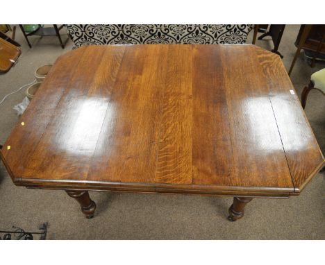 A Victorian wind-out extending dining table, the moulded top with canted angles and two additional leaves, raised on turned t