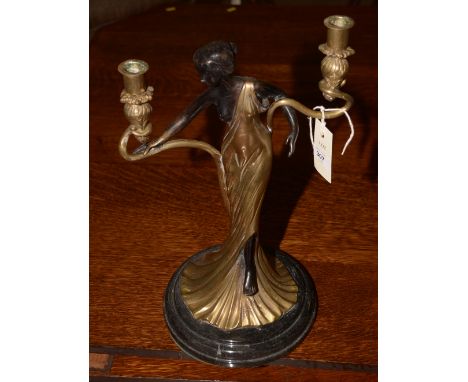 Art Noveau style brass figural candlestick.