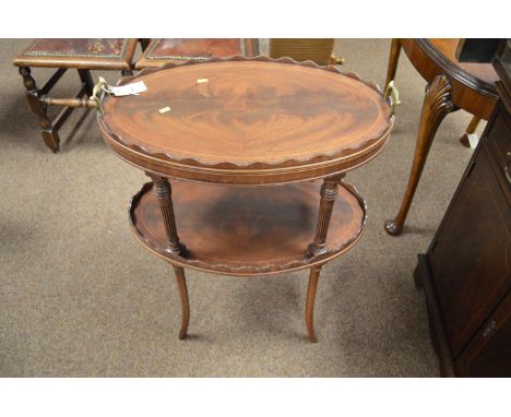 A 20th Century mahogany etagere, with undulating gallery and brass handles, fluted supports above a second shelf, raised on o