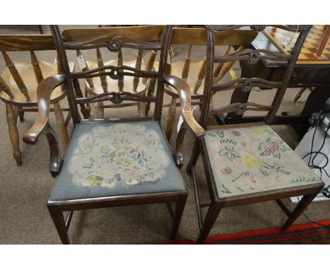 Two George III style dining chairs, including one carver, with acanthus carved top rail and pierced ladder backs, the drop-in