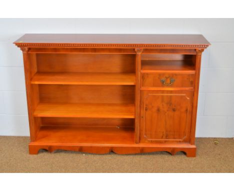 A 20th Century yew open bookcase, retailed by Maple &amp; Co., the rectangular top above an open bookcase to one side and sin