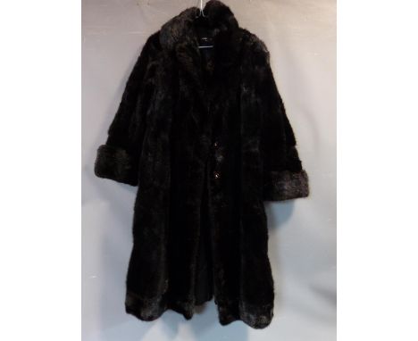 A vintage long black mink fur coat by R C Winterson Ltd. Embroidered name patch to inside with black silk lining. Length 118 