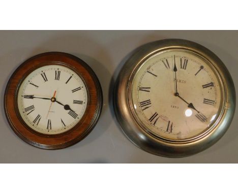 Two Victorian style wall clocks, one with wooden surround and one with antique metal finish. Both clocks have roman numerals.