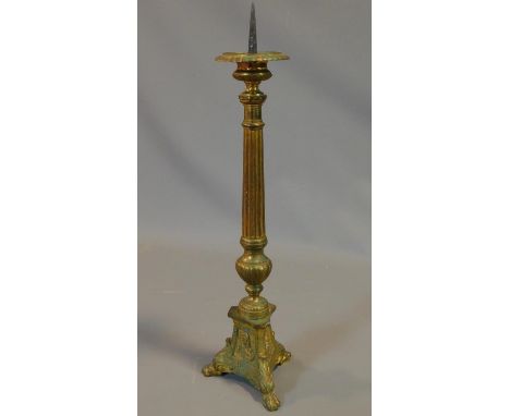 An antique brass Gothic style pricket candle stick. H.61cm 