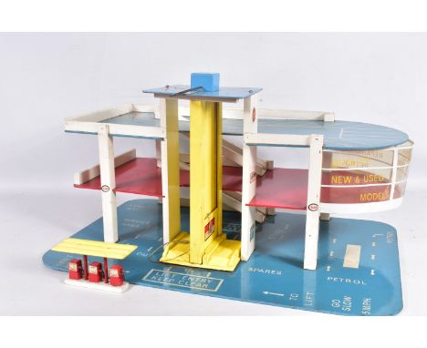 A VINTAGE WOODEN THREE TIERED MODEL SERVICE STATION WITH LIFT, in blue, white, red and yellow, with a two car lift with broke