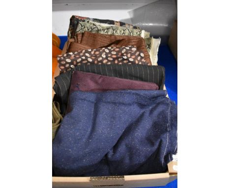 A box of traditional and retro fabric, including needle cord and vintage flecked wool in navy blue.