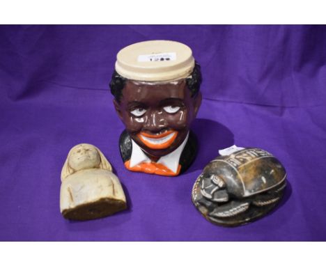 Two Egyptian items including stone carved scarab beetle and a bust with a vintage character mug.