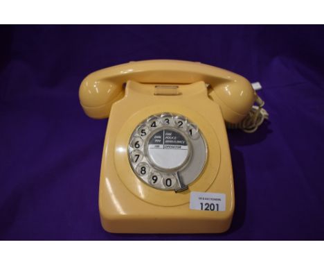 A vintage GPO telephone set in a light peach colour.