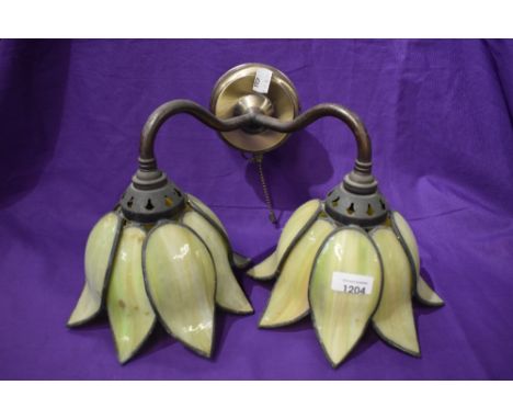 A modern wall mounted light with double branch in the form of a lily with coloured leaded light shades.