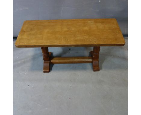 Robert 'Mouseman' Thompson, an adzed oak coffee table raised on trestle supports, with mouse carved in high relief to leg, H.