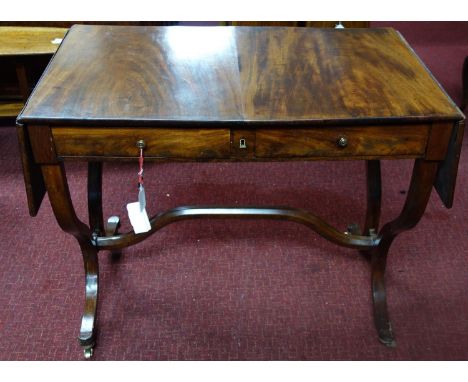 A mahogany sofa table, with a pair of drop flaps and two small drawers, on outswept legs joined by shaped stretcher, on casto